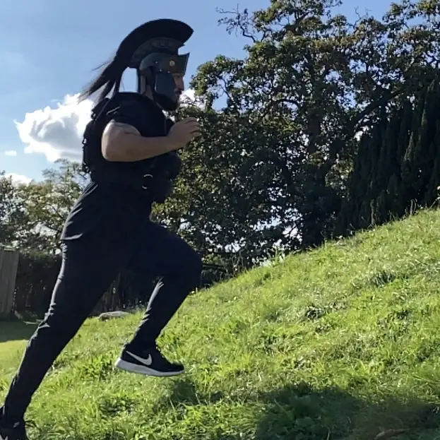 Olgun Tiltay of  Shuhari Self Defence running uphill with a weight jacket in Maidenhead